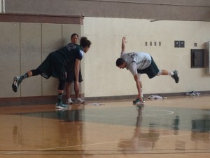 Athletic trainer Jay Goo puts Fotu and Jankovic through some exercises.