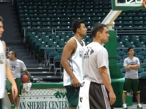 Jawato watched a drill next to assistant Brandyn Akana.