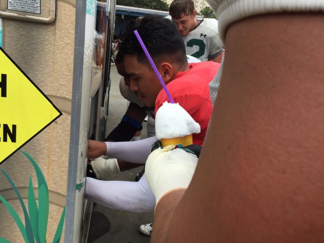 Quarterback Ikaika Woolsey using the syrup dispenser