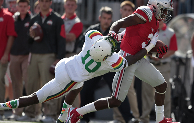 Ohio State wide receiver Michael Thomas stiff-armed Hawaii defensive back Marrell Jackson in the first half.