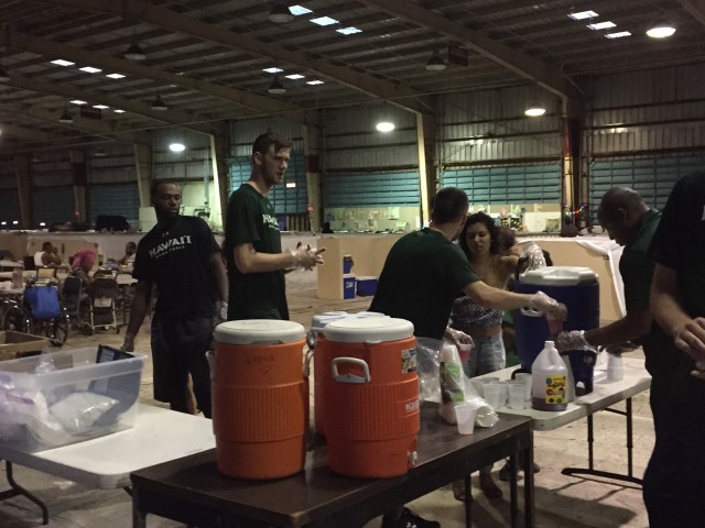 UH players served food and water inside the shelter warehouse.