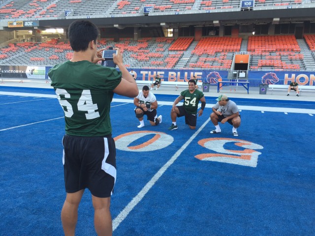 Long-snapper Noah Borden  takes a picture of offensive lineman Eperone Moananu, nose tackle Kiko Faalologo, and linebacker Jamie Tago