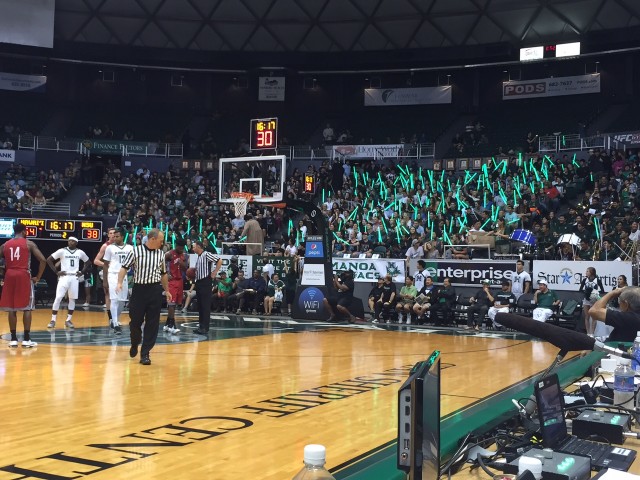 The UH student section waves lightsabers during a Nicholls State free throw.