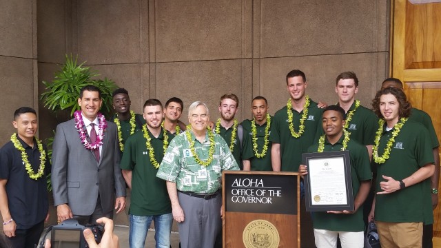 Members of the men's basketball team posed with Manoa chancellor Robert Bley-Vroman outside the Governor's Office.