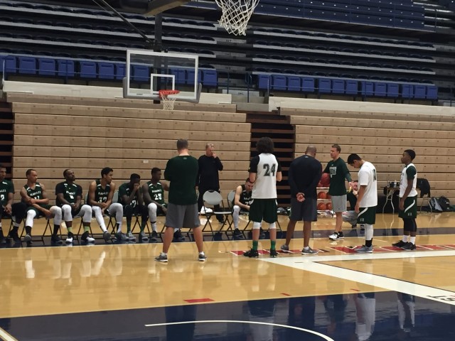 Assistant coach John Montgomery (right, with basketball) has taken point on scout preparation for his old school.
