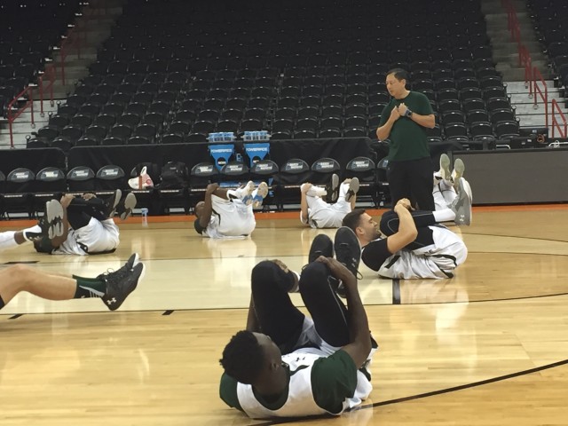 Athletic trainer Jay Goo put the team through warmup stretches.