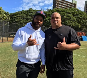 Michael Bennett and O-line coach Chris Naeole. Bennett owns a house in Hawaii and spends about six months here each year. He also is a self-proclaimed "Hawaii fan." Bennett offered tips to UH's defensive linemen. 