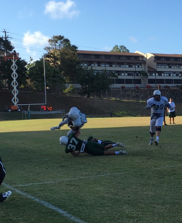 Cornerback Austin Gerard tackles running back Paul Harris