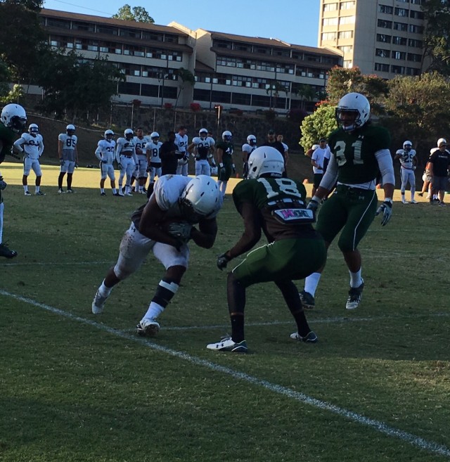 Running back Diocemy Saint Juste, cornerback Roe Farris and middle linebacker Jahlani Rogers (31)