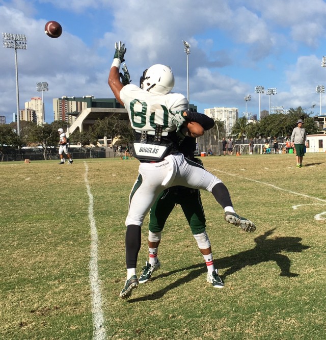  Right wideout Ammon Barker and left cornerback Jalen Rogers engage in their daily battle. 