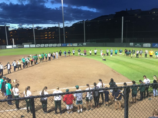 The Rainbow Wahine softball team and their families and friends formed a circle for a postgame prayer following Saturday's senior day ceremony.