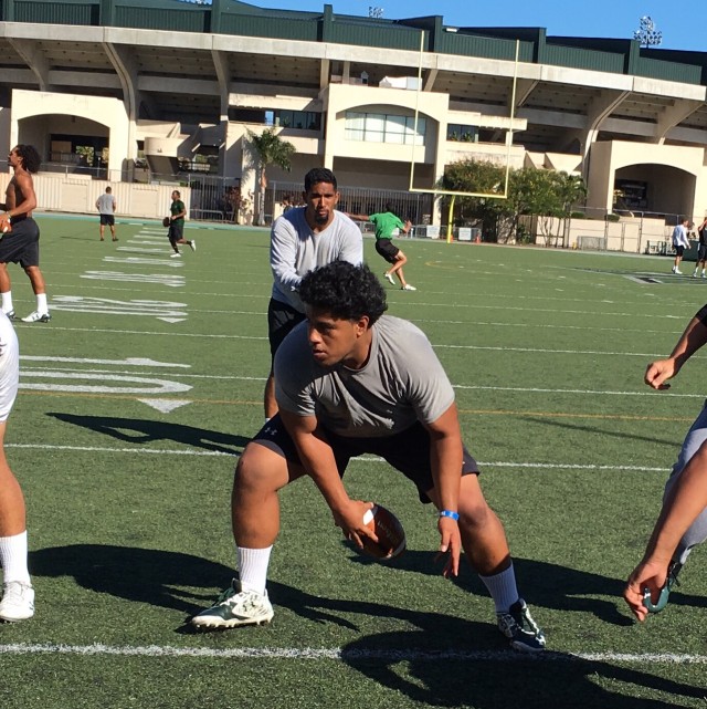 Defensive tackle Samiuela Akoteu (portraying a center) and Makani Kema-Kaleiwaheaa (as a QB)