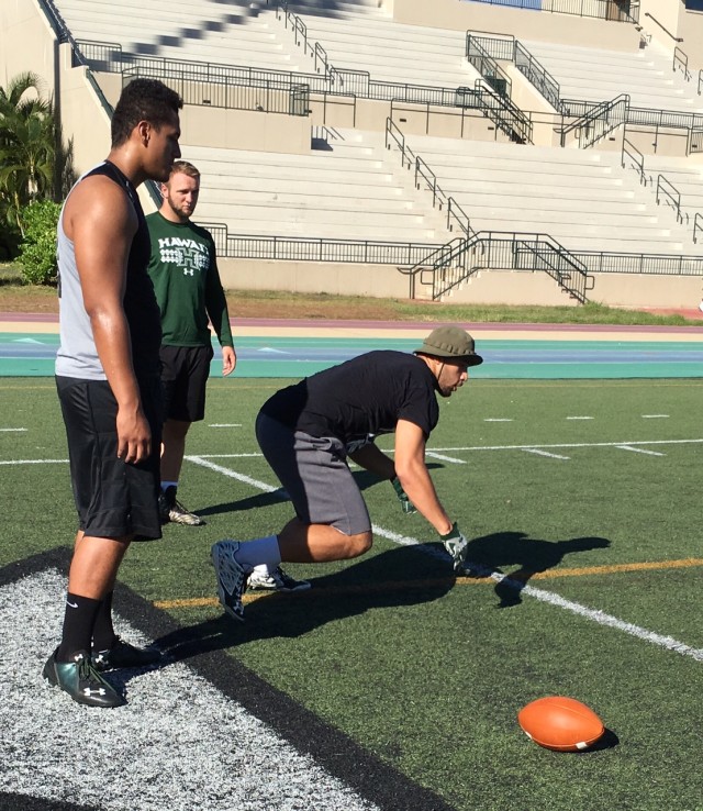 David Manoa demonstrates a technique to Vince Moala and Cole Carter