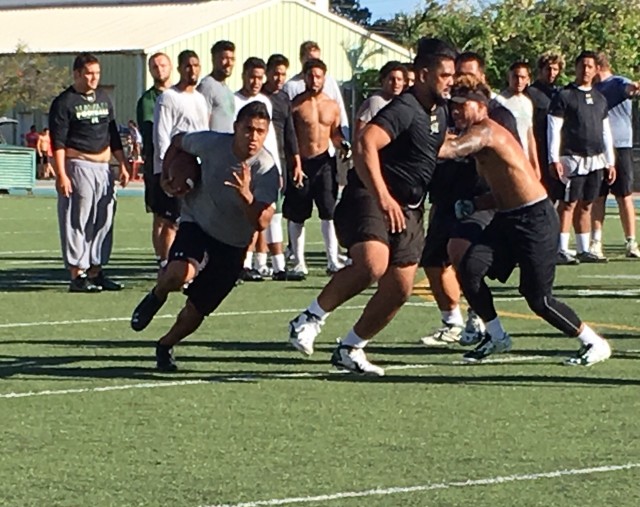 Running back Steven Lakalaka following Leo Koloamatangi's pulling block