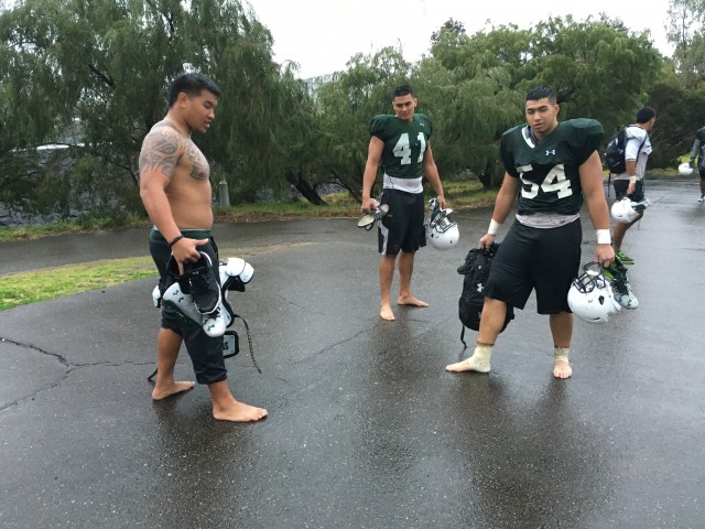After a muddy practice, the players walked back to their hotel 