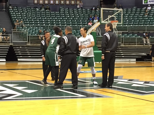 Green and White captains Briana Harris and Sarah Toeaina have their pregame meeting with the officials.