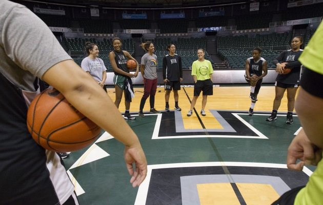 Laura Beeman shares a laugh with the Rainbow Wahine basketball team prior to practice at the Stan Sheriff Center. Photo by Cindy Ellen Russell/Star-Advertiser