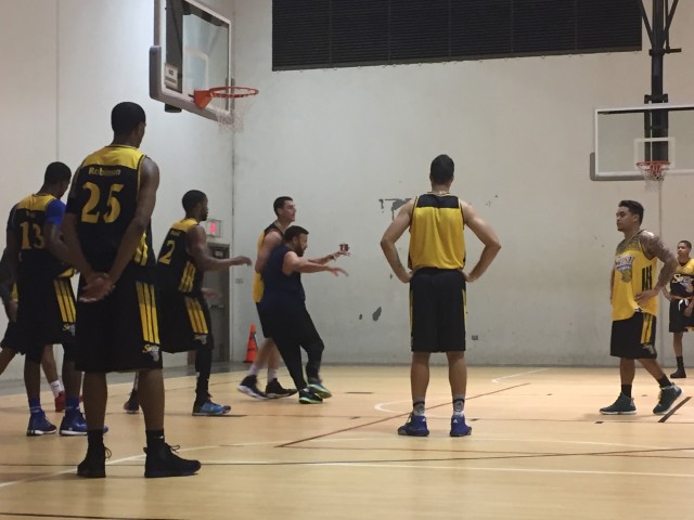 Hawaii Swish co-coach Artie Wilson demonstrated a post-up move as owner/player Geremy Robinson (left) observed at a December practice.