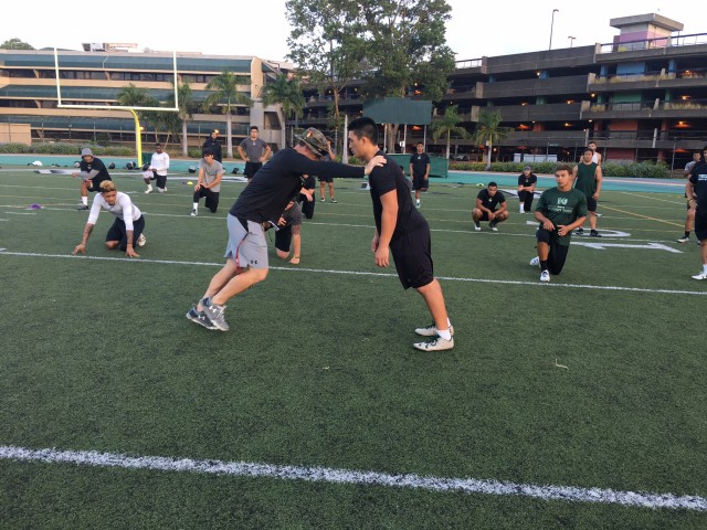 Strength/conditioning coordinator Bubba Reynolds  and rush end Kaimana Padello